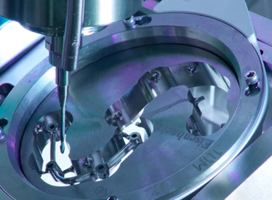 Close-up of the rotary axis milling a dental restoration in The Smile Bar's in-house lab