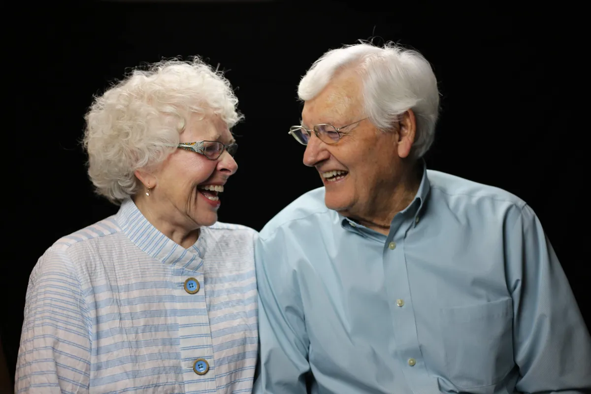 Older couple laughing together — the confidence All-on-4 full-arch restoration restores