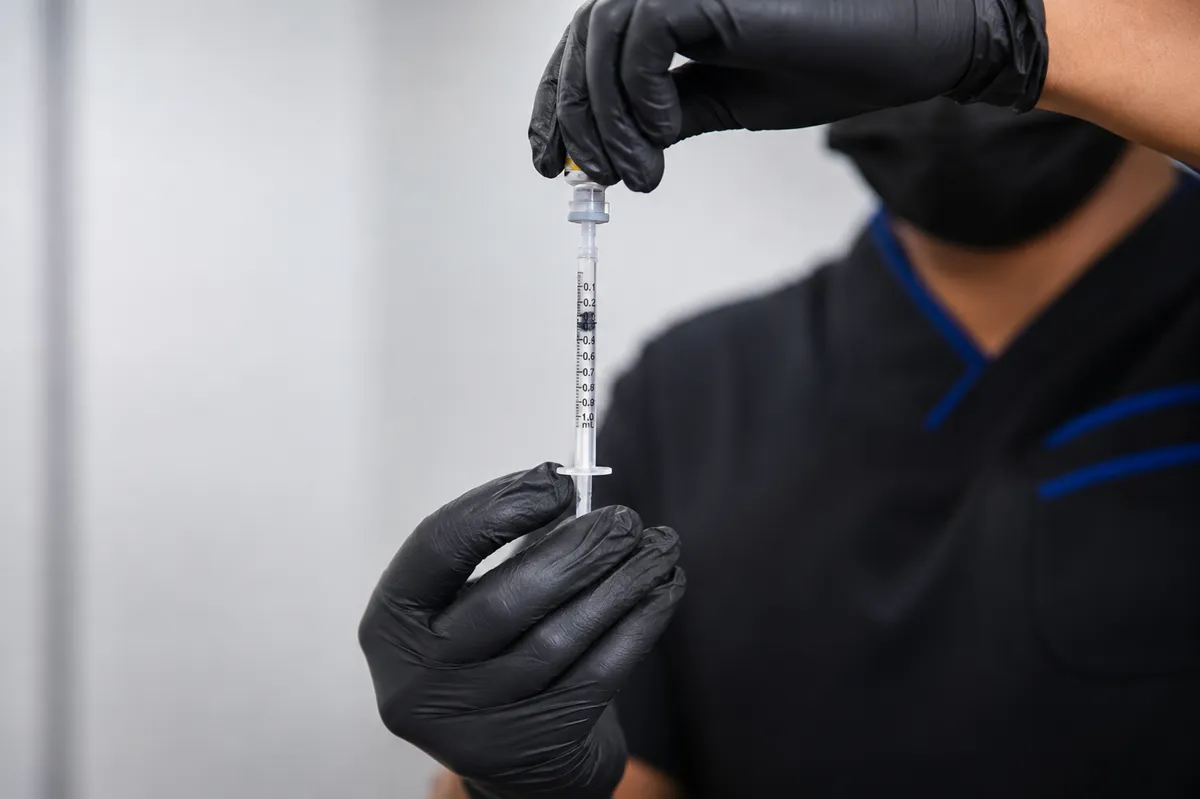 Practitioner preparing a precise Botox syringe