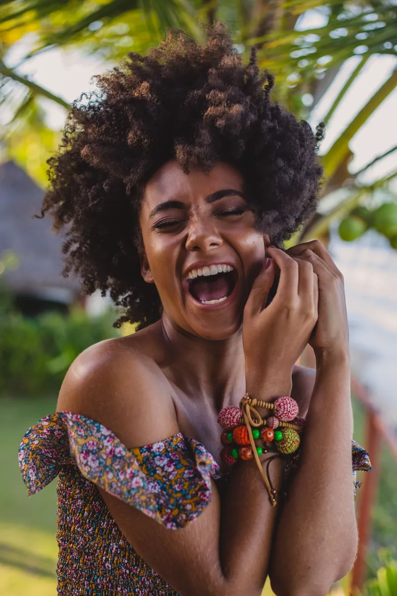 Woman laughing joyfully — cosmetic dentistry confidence