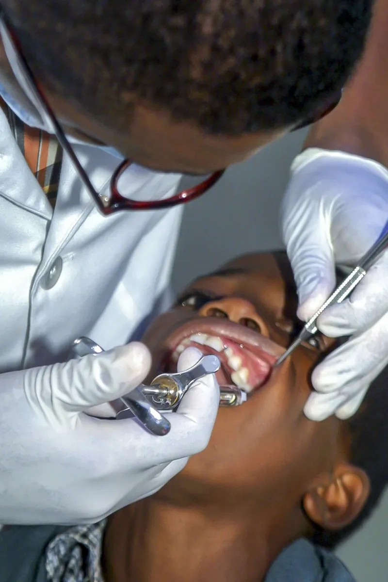 Dentist examining a young patient at a preventive visit