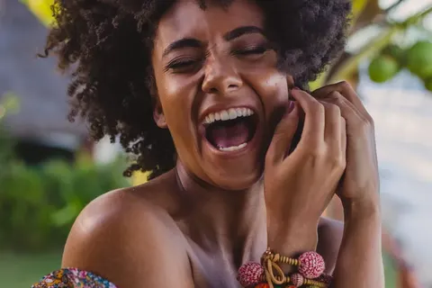 Woman laughing, showing a bright, even smile