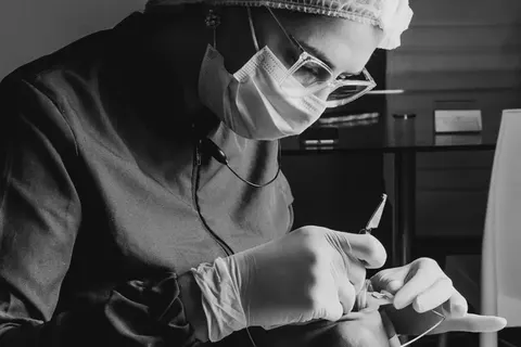 Black-and-white photograph of a dentist at work